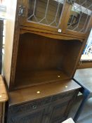 A linen fold bookcase with cupboard base