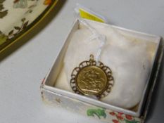 A full gold sovereign with mount dated 1908