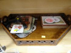 A carved galleried twin-handled tray and sundry table mats