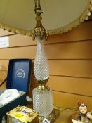 A glass and polished metal electric table lamp and shade