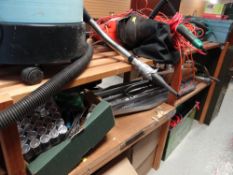 A garage shelving unit and extensive contents including Bosch trimmer, garden blower, tools, mower