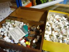 An antique mahogany box with contents of thimbles etc