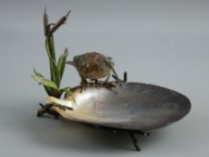 AN AUSTRIAN COLD PAINTED BRONZE STUDY OF A BIRD perched on a branch amongst bullrushes on a branch