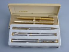 A THREE PEN DESK SET and a two pen desk set, both cased