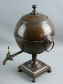 AN EARLY 19th CENTURY COPPER TEA URN, ball shaped with knopped lid and ring handles and on a short
