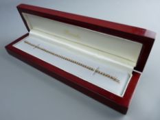 A NINE CARAT GOLD RENATO BRACELET with tiny cubic zircons, 9.5 grms gross, cased