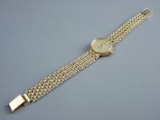 A LADY'S NINE CARAT GOLD ENCASED CIRCULAR DIAL SOVEREIGN WRISTWATCH with seven band nine carat