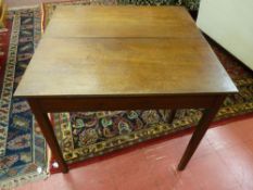 A GEORGIAN OAK FOLDOVER TEA TABLE, the rectangular top with reeded edging above a plain frieze on