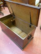 AN ANTIQUE OAK LIDDED CAPTAIN'S CHEST with iron carry handles and lock, having an interior candle