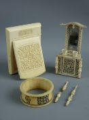 AN IVORY COMPACT, a Napoleonic carved bone ornament and a napkin ring, the lidded compact carved