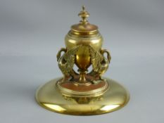 AN EMPIRE STYLE BRASS INKSTAND, the 16.5 cms diameter base supporting a stepped platform with