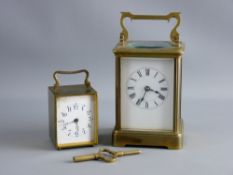 TWO FRENCH BRASS CASED CARRIAGE CLOCKS, the larger with white enamel dial set with Roman numerals,
