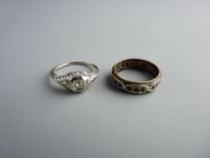 AN EIGHTEEN CARAT WHITE GOLD DIAMOND DRESS RING, 1.3 grms and a wide eternity ring