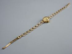 A LADY'S NINE CARAT GOLD ENCASED OVAL DIAL ROTARY WRISTWATCH with nine carat gold patterned link