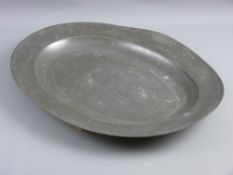 A LATE 18th/EARLY 19th CENTURY OVAL PEWTER MEAT PLATTER with semi-legible London touch marks to