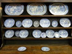 A TWENTY PIECE WILLOW PATTERN DRESSER SET to include three meat platters as displayed on Lot 19