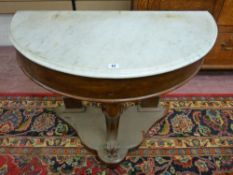 A VICTORIAN MAHOGANY WASHSTAND BASE with semi-circular white marble top and carved central leg