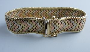 A NINE CARAT GOLD SEVEN BAND MULTI-COLOUR BRACELET, 30 grms
