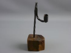 AN ANTIQUE WROUGHT IRON RUSH LIGHT HOLDER, late 18th/early 19th Century in twisted form, the nip