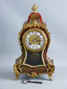 A FRENCH BOULLE MANTEL CLOCK of waisted form with gilt metal mounts and brass inlay on red