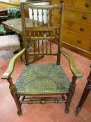 AN EARLY 19th CENTURY ASH & ELM LANCASHIRE ELBOW CHAIR with triple spindle gallery back, rush seat