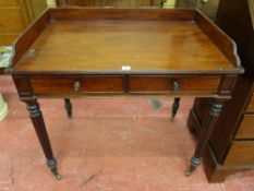 A VICTORIAN MAHOGANY TWO DRAWER SIDE TABLE, the rectangular top and three quarter gallery with