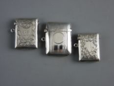 THREE HALLMARKED SILVER VESTA CASES, two having bright cut decorations, all with Birmingham