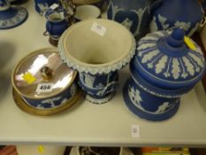 Three items of blue Wedgwood Jasperware comprising biscuit barrel with domed lid, twin-handled
