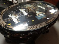 A late twentieth century fancy oval Japanese-style nest of tables in black lacquer with mounted