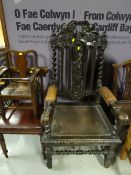 A Victorian stained and carved elbow chair with leather padded arms, barley-twist supports