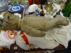 An early twentieth century English teddy bear with growler and articulated limbs together with two