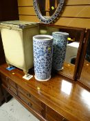 A loom linen basket, a blue & white pottery umbrella stand and a modern oval mirror