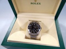 A ROLEX OYSTER PERPETUAL SUBMARINER SUPERLATIVE CHRONOMETER with chrome bracelet, graphite di