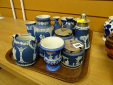 A quantity of blue Wedgwood Jasperware table items including jugs, pepperettes, conserve pots etc