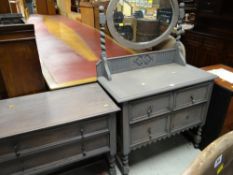 A modern two-door filing cabinet together with a vintage carved two-drawer dressing table on