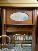A vintage overmantel with oval mirror cartouche together with an antique brass bedstead