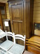 A linen-fold hall robe and two white painted chairs