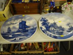 A pair of blue & white circular Delft painted plaques, no. 57 and no. 9 (both signed)