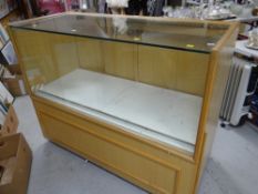 A lightwood and glass counter display