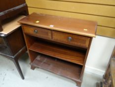 A small mahogany effect bookcase with drawers