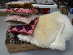 Three sheepskin rugs and sundry tapestry cushions etc