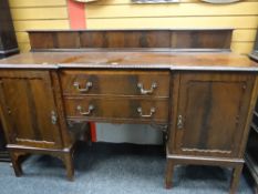 A mahogany breakfront railback sideboard