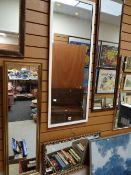 A white framed hall mirror and another