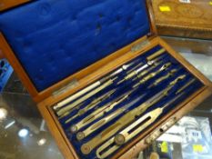 A vintage mahogany encased drawing instrument set