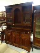 A good modern linen fold dresser having a base of cupboards and drawers and a semi-glazed top