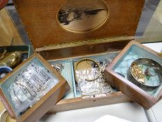A marquetry musical box with fold out compartments containing costume jewellery items