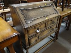 A vintage Jacobean revival bureau on barley-twist supports and bun feet