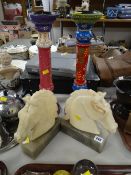 A pair of alabaster horse head bookends and a pair of bargeware-style painted wooden candlestick