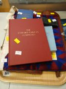 An auction house tray with Masonic items including booklets and aprons