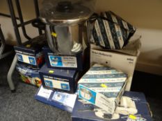 A quantity of boxed stainless steel various kitchen pans